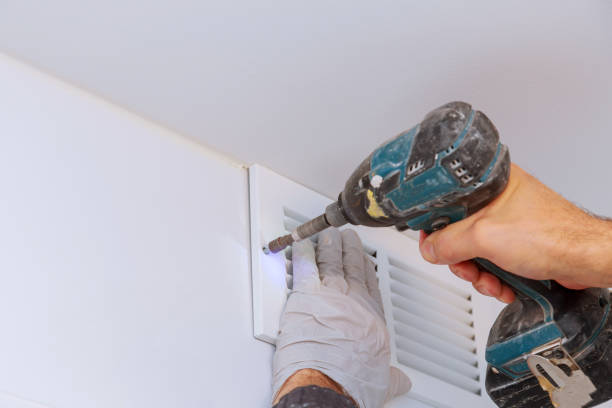 istock Man is holding hand drill in hands. Worker installing the wall bathroom vent works renovation in the flat. 1138371242