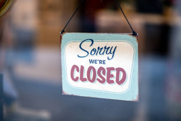 istock Sorry we're closed sign on store window door 1138371455