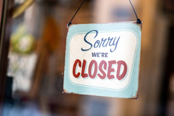 Sorry we're closed sign on store window door