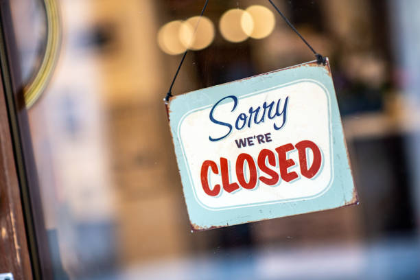 istock Sorry we're closed sign on store window door 1138371998