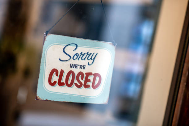 istock Sorry we're closed sign on store window door 1138372142