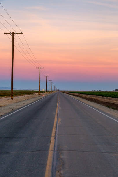Looking down a long, straight road at sunset