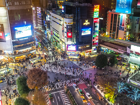 Shibuya, Tokyo, Japan - December 2018 : Shibuya Crossing from aerial view with tourists walking cross street in evening. One of destination in Japan