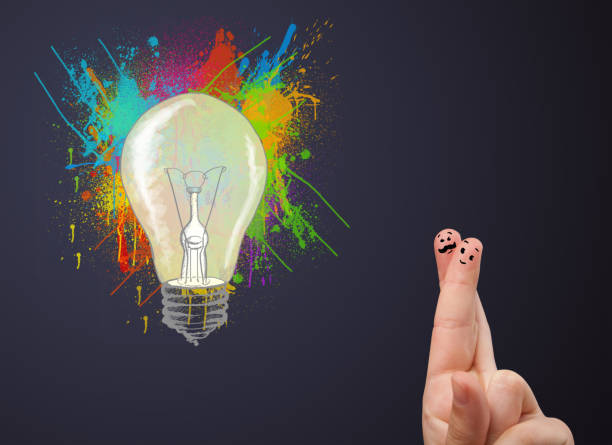 istock Happy smiley fingers looking at abstract hand drawn colorful light bulb 1138375212