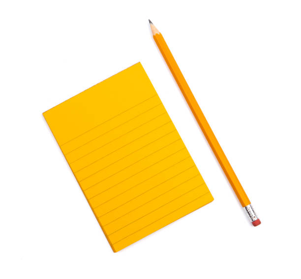 istock A striped notebook with orange sheets next to which lies a sharpened pencil on white background. Mock up with copy space for text 1138375379