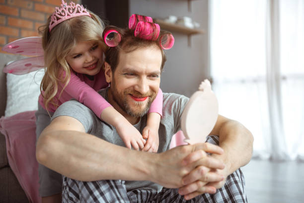 istock Cheerful father has make-up on face and hairdo 1138375596