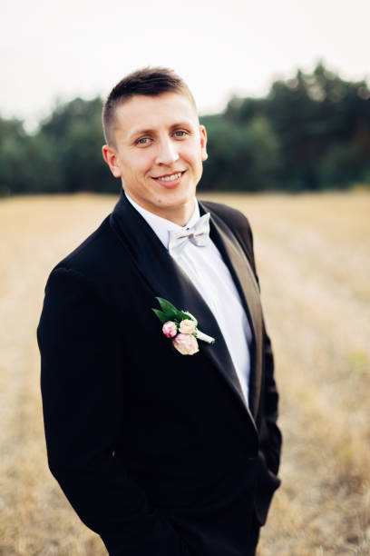 istock Portrait of a handsome groom in a black tuxedo with a bow-tie. 1138375607