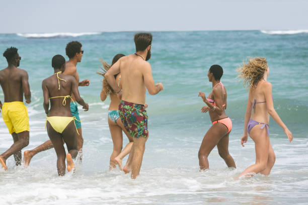 istock Group of friends enjoying at beach 1138376974