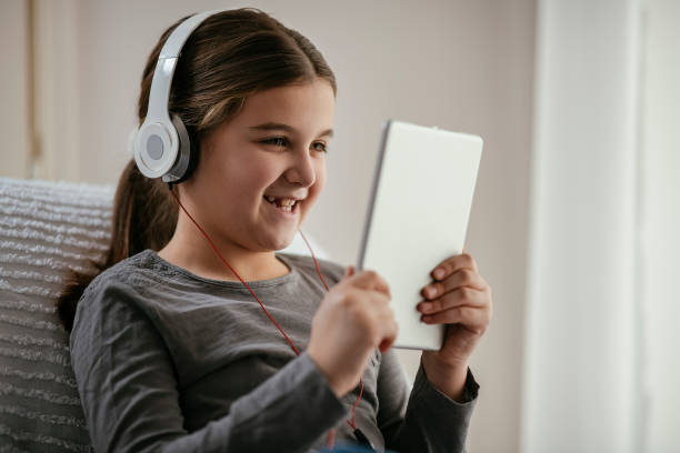 istock Girl using tablet and listening music 1138378260