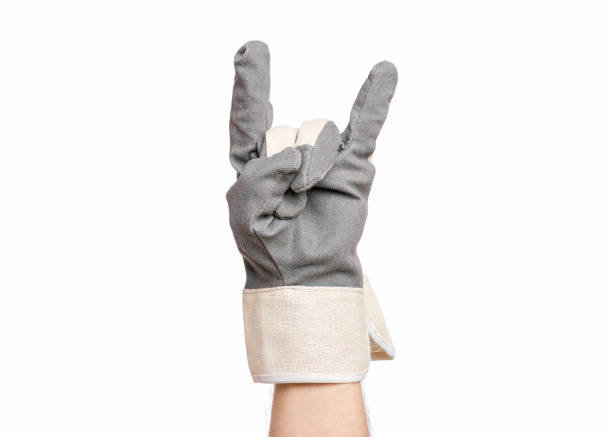 Construction glove yellow. Index finger points to side. Isolated object on white background. Symbol or sign. Directional sign or call to pay attention