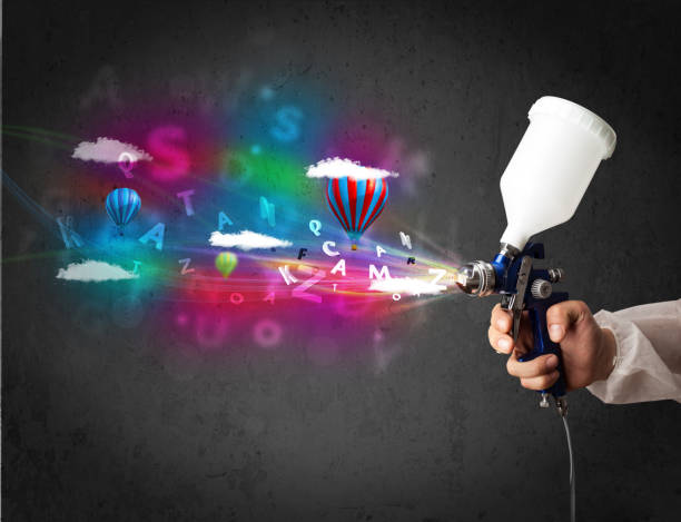 istock Worker with airbrush and colorful abstract clouds and balloons 1138379927