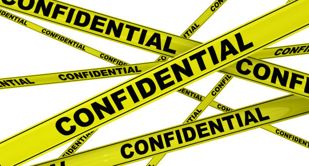 istock Confidential. Labeled yellow warning tapes 1138380794