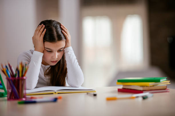 happy little girl studying - child thinking writing little girls imagens e fotografias de stock