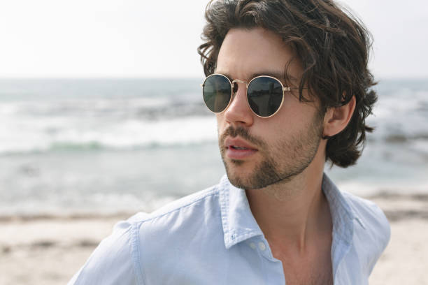 istock Caucasian man standing at beach on a sunny day 1138380951