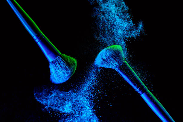 make up cosmetic brushes with powder blush explosion on black background. skin care or fashion concept. nice blue neon lighting - face powder exploding make up dust imagens e fotografias de stock