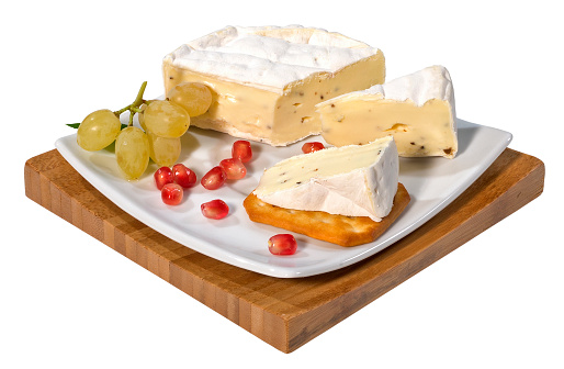 Camembert or brie cheese with truffle on a serving board,isolated on white with clipping path.