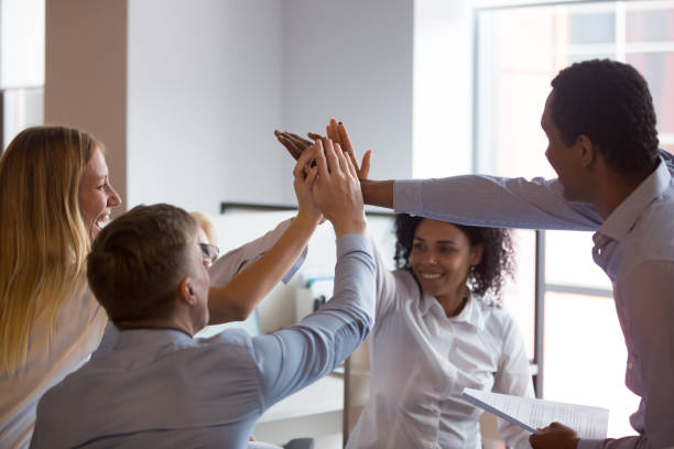 istock Multiracial employees giving high five at briefing, showing unity 1138382774
