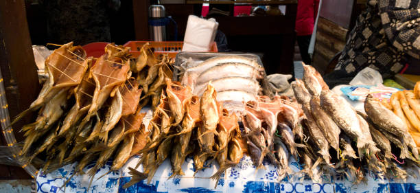 Counter with different kinds of cooked fish. Hot smoked fish on the counter in Listvyanka. Baikal sea food stock photo