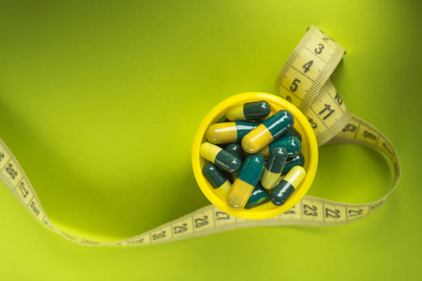 istock Green and yellow medicine capsule 1138384820