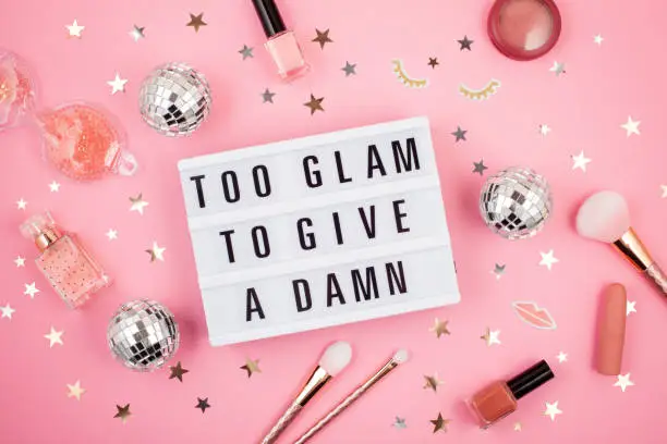 Flat lay of  lightbox with funny motivation, inspiration phrase Too glam to give a damn