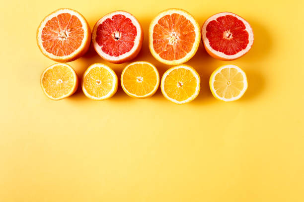 istock Flat lay slices of different raw fresh citrus fruit over yellow background. 1138385250