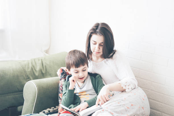 istock Mother and son reading a book together 1138385265