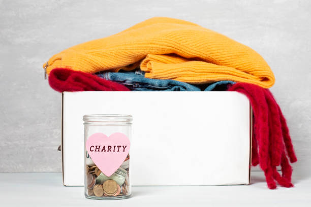 istock Coins, banknotes in money jar and box with donations 1138385320