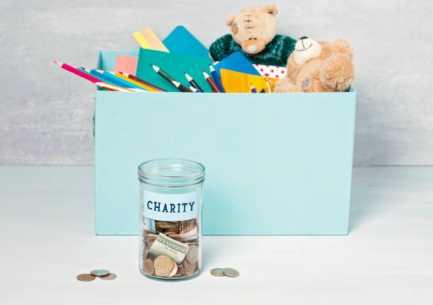 istock Coins, banknotes in money jar and box with donations 1138385329