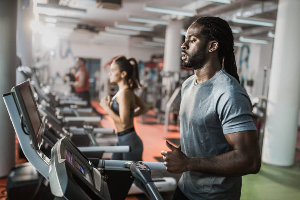 istock Young black athlete running on treadmill in a gym. 1138386578