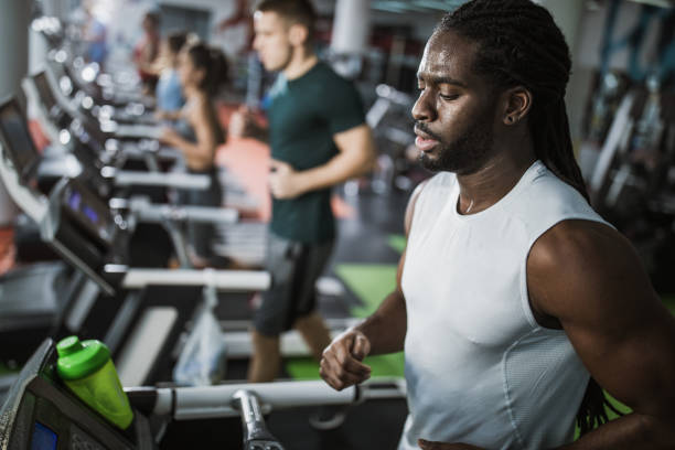 istock Sweaty black athlete running on treadmill in a gym. 1138387734
