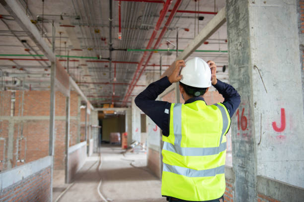 engineering supervisor is very sad after end job in construction site - protective workwear hat violence construction imagens e fotografias de stock