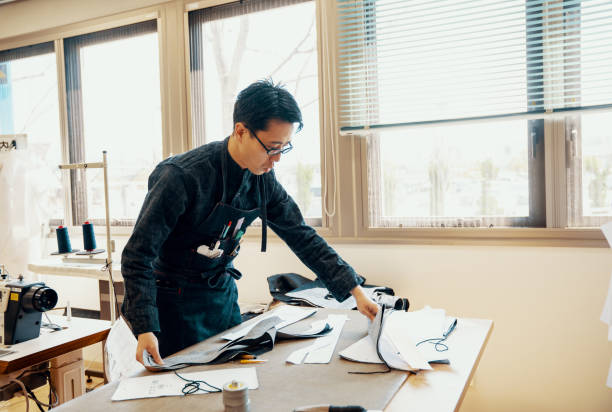 istock Mid adult tailor working in his design studio creating denim products 1138387912