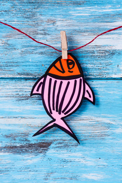 a homemade paper fish, made by myself, as a popular prank for april fools day in countries such as Italy, France, Belgium, Netherlands, Switzerland or Canada hanging from a rope with a clothespin