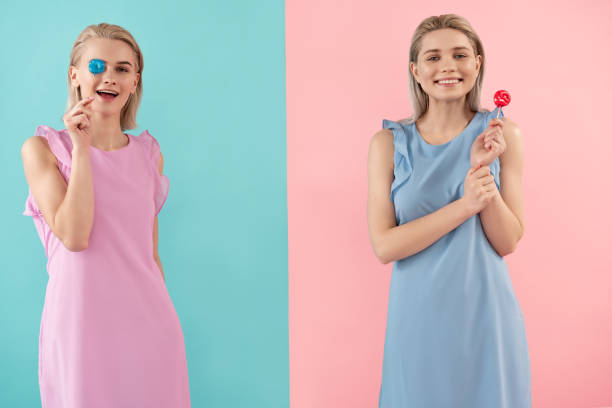 istock Blonde twins enjoying delicious candies 1138393524