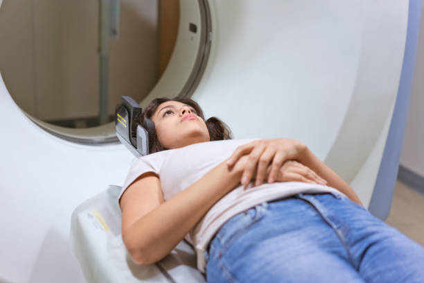 istock Young female patient undergoing through CAT scan 1138393583