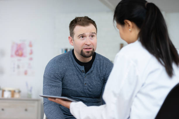istock Man listening to results 1138394971