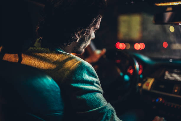 istock Man driving a car at night 1138395112