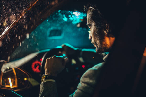istock Man driving a car on a rainy night 1138395591