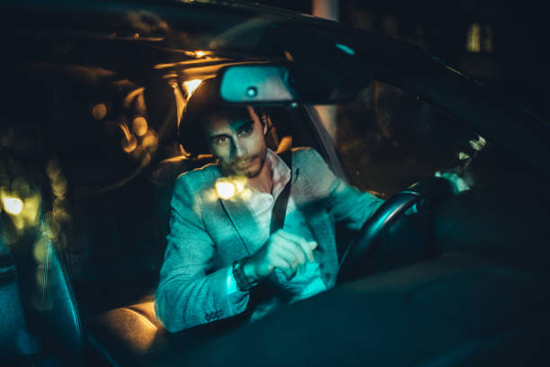 istock Handsome gentleman driving a car at night 1138395744