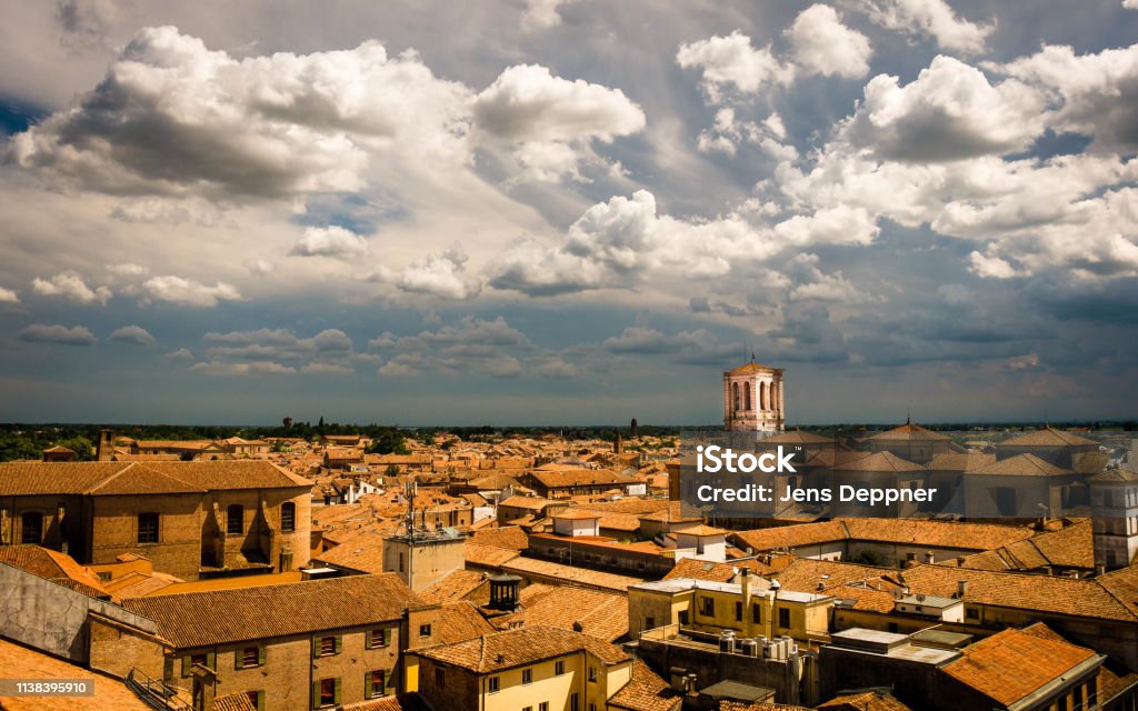View over the red roofs of Ferrara, Italy, during an approaching thunderstorm Aerial View of the medieval city Ferrara Stock Photo
