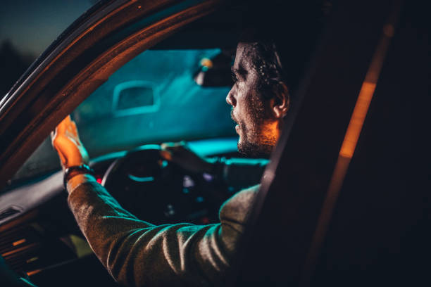 istock Nervous man driving a car at night 1138396046