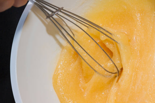 istock Sugar is mixed with beaten egg for dessert 1138397650