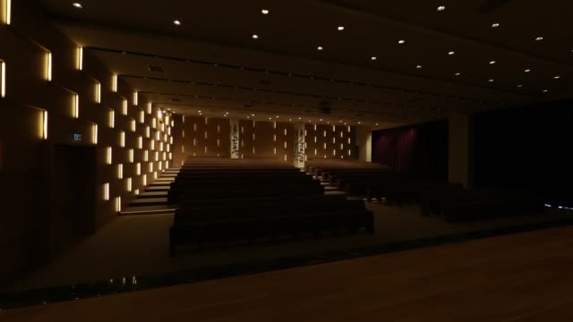 Light switched on/off, in empty conference hall with rows of seats for spectators and audience.
