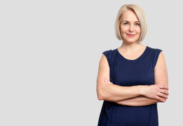 istock Friendly smiling middle-aged business woman isolated on white ba 1138401573