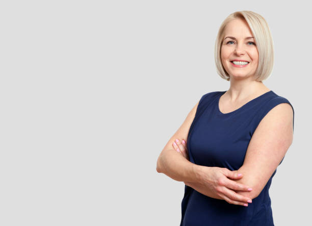 friendly smiling middle-aged business woman isolated on white ba - women smiling blond hair human face imagens e fotografias de stock