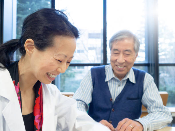istock Asian doctor talking to senior patient 1138402034