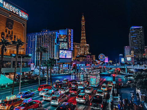 The Las Vegas strip at night with cars lined up on the road