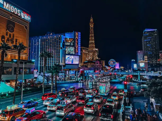 The Las Vegas strip at night with cars lined up on the road