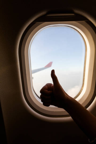 istock Plane wing view from inside plane in midair with blue sky cloud background 1138402086