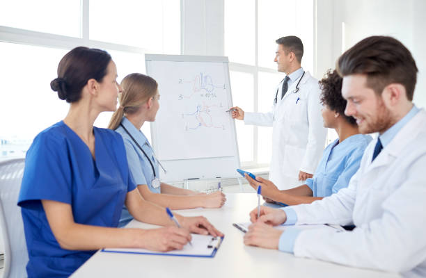 istock group of doctors on presentation at hospital 1138403651